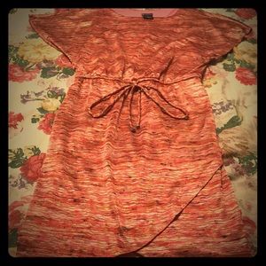 Short sleeve, knee length dress with tie in front.